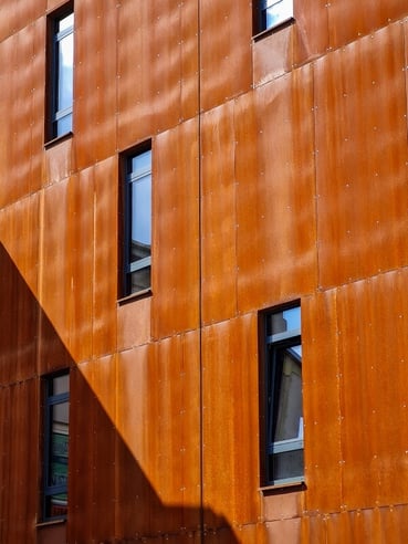 Why pick corten steel buildings (vs traditional materials shown)